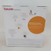The image shows the packaging of a Beurer infrared heat lamp, with various features and benefits highlighted through text and icons. Anteprima dell’immagine prodotto