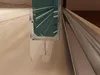 Close-up view of a shower door seal and track. Produktbild-Vorschau