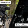A split image showing a person riding a bicycle with a handlebar bag during the day and at night. Podgląd zdjęcia produktu