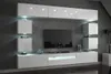 A modern white media console and shelving unit mounted on a gray wall, with a television and decorative items. Produktbild-Vorschau