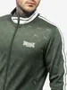 Close-up of a man wearing a green Lonsdale tracksuit. Náhled obrázku produktu