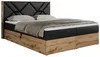 A studio shot of a boxspring bed with a black upholstered headboard and black base, featuring wooden drawers. Produktbild-Vorschau