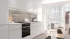 A modern kitchen with a couple in the background. Produktbild-Vorschau