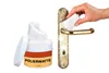 A jar of polishing cotton and a brass door handle being polished. Produktbild-Vorschau