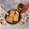 Waffles with honey and nuts on a gray surface. Produktbild-Vorschau