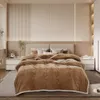 A neatly made bed with a brown comforter in a bedroom setting. Produktbild-Vorschau