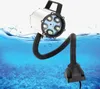 A waterproof LED work light with a flexible gooseneck submerged in blue water, with a coral reef visible below the surface. Podgląd zdjęcia produktu