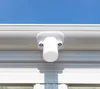 A close-up view of a white plastic fitting attached to the white frame of a carport, with a clear blue sky in the background. Podgląd zdjęcia produktu