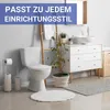 A clean and modern bathroom scene featuring a toilet, sink, and vanity. Produktbild-Vorschau