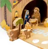 A close-up view of a wooden nativity scene with animal figures in the foreground. Produktbild-Vorschau