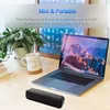 A desk setup with a laptop, a plant, a mug, and a speaker. Produktbild-Vorschau