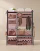 A multi-level storage unit with shelves and hooks, displaying various items like hats, scarves, jackets, bags, and shoes. Produktbild-Vorschau