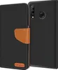 A black flip case wallet for a Huawei P30 Lite phone is shown open, revealing the phone's back and camera module. The case has a brown leather strap closure and a small brown logo on the front flap. Anteprima dell’immagine prodotto