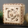 A wooden 3D puzzle safe with intricate gears and a dial. Produktbild-Vorschau
