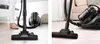 Collage of a vacuum cleaner head on different floor types, with a person's legs visible in one frame. Podgląd zdjęcia produktu