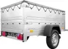 A silver utility trailer with a gray tarp cover is shown from a three-quarter rear view against a white background. Náhled obrázku produktu