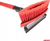 A close-up, angled view of a red and black snow brush with an integrated ice scraper, set against a plain white background. Podgląd zdjęcia produktu