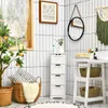A bathroom scene with a white cabinet, baskets, and a plant. Náhled obrázku produktu