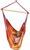 A woman relaxing in a colorful hammock chair. Produktbild-Vorschau