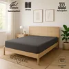 A bed with a grey fitted sheet in a bedroom setting. Produktbild-Vorschau