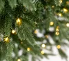 Close-up of green artificial Christmas tree branches with warm white LED lights. Náhľad obrázku produktu