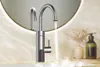 A modern kitchen faucet with a digital display, set against a marble countertop and a round mirror. Podgląd zdjęcia produktu