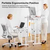 Two women are shown using adjustable standing desks in an office setting. One woman is seated at a desk with a laptop, while the other stands at a taller desk with a computer monitor. Podgląd zdjęcia produktu