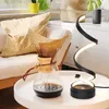 A modern spiral LED desk lamp is placed on a white table next to a Chemex coffee maker filled with coffee. Podgląd zdjęcia produktu