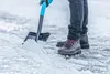A person is shoveling snow with a shovel. Náhľad obrázku produktu