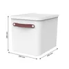 A white storage box with brown handles is shown against a white background with dimension lines and measurements. Produktbild-Vorschau