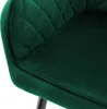 A close-up view of a dark green velvet dining chair. Produktbild-Vorschau