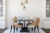 A dining set with chairs and a table under pendant lights. Voir les images du produit