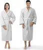 A man and a woman are standing and posing in white bathrobes. Produktbild-Vorschau