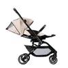 A side view of a khaki and black stroller against a white background. Produktbild-Vorschau