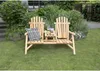 A wooden bench with an integrated table sits on a green lawn in a garden setting. Produktbild-Vorschau