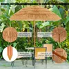 A straw-like patio umbrella is set up outdoors with chairs and a table. Náhled obrázku produktu