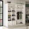 A white wardrobe with clothes and accessories inside, set in a bedroom. Produktbild-Vorschau