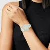 A woman's arm wearing a white watch. Náhled obrázku produktu