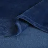 A close-up view of a folded dark blue blanket, showing its soft texture and stitching. Produktbild-Vorschau