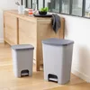 Two pedal bins are placed on a wooden floor next to a wooden cabinet. Náhled obrázku produktu
