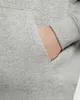 A close-up shot of a person's hand in the pocket of a gray hoodie. Anteprima dell’immagine prodotto