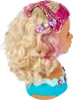 A styling head with blonde hair and pink highlights, decorated with hair accessories. Produktbild-Vorschau