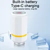 A white cylindrical vacuum sealer with a yellow band and a red power button is placed on a clear surface with clear geometric shapes around it. Produktbild-Vorschau