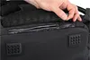 A hand is shown zipping up a compartment on a black rucksack. Produktbild-Vorschau