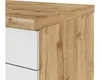 A close-up view of the corner of a kitchen cabinet, showing the wood grain texture and a white drawer front. Náhled obrázku produktu