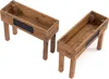 Two wooden planter boxes with legs and a chalkboard insert on a white background. Produktbild-Vorschau