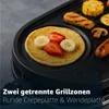 A close-up of a raclette grill with a pancake topped with strawberries and bananas, and other food items like sausage, corn, and zucchini on the grill. Produktbild-Vorschau
