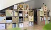 A modular shelving unit filled with books, baskets, and decorative items, placed against a wall and under a sloped ceiling. Anteprima dell’immagine prodotto