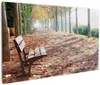 Wallario Premium Leinwandbild Einsame Parkbank an einer Produktbild-Vorschau 1
