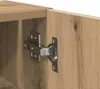 A close-up view of a cabinet hinge attached to a wooden cabinet. Podgląd zdjęcia produktu